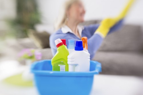 Staff applying cleaning solution with safety precautions